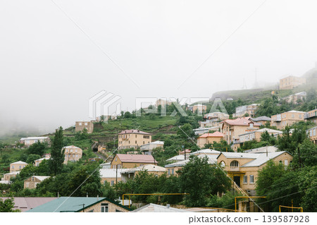 Misty hillside village houses in Kubachi with green terraces, Dagestan mountains 139587928