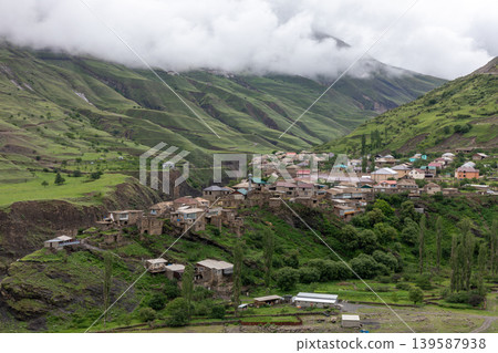 Mountain village panorama of Magar in Dagestan with green hills and low clouds Mountain village panorama of Magar in Dagestan with green hills and low clouds 139587938