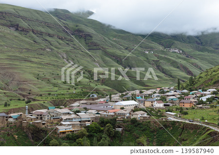 Mountain village of Magar in Dagestan with green hills and low clouds Mountain village of Magar in Dagestan with green hills and low clouds 139587940