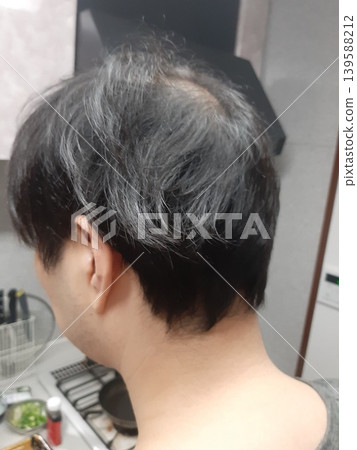 The back of a man's head; the back view of a man with black hair. The back of a man's head; the back view of a man with black hair. 139588212