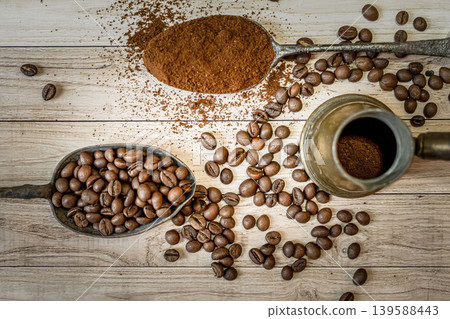 Spoon with instant coffee powder and beans on wooden background, flat lay Spoon with instant coffee powder and beans on wooden background, flat lay 139588443