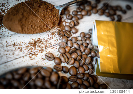 Spoon with instant coffee powder and beans on wooden background, flat lay Spoon with instant coffee powder and beans on wooden background, flat lay 139588444