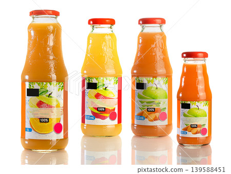 Juice in a glass bottle, bright colored drink on a white background isolated Juice in a glass bottle, bright colored drink on a white background isolated 139588451
