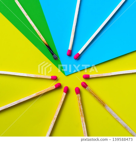 Success, defeat, achievement. The concept of happiness. Matches on a yellow background. Burnt dark match among normal matches. Burning match fire to its neighbors, a metaphor for ideas and inspiration Success, defeat, achievement. The concept of happiness. Matches on a yellow background. Burnt dark match among normal matches. Burning match fire to its neighbors, a metaphor for ideas and inspiration 139588473