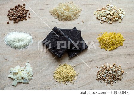 Assorted cereal grain porridge seeds set on a wooden background: buckwheat, rice, semolina, wheat, couscous, oatmeal Assorted cereal grain porridge seeds set on a wooden background: buckwheat, rice, semolina, wheat, couscous, oatmeal 139588481