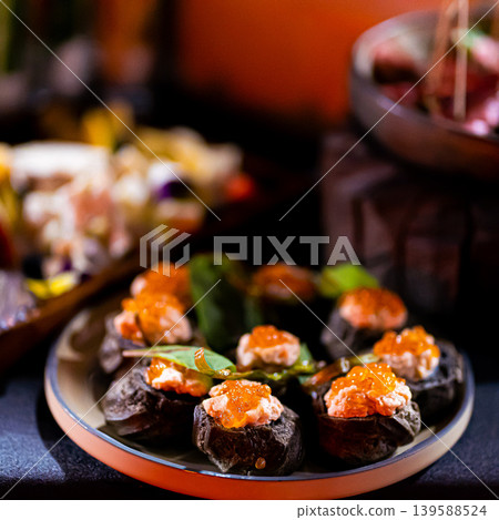 Pumpernickel bread sandwich snack with cured smoked salmon and fresh avocado served as close-up on a wooden cutting board 139588524