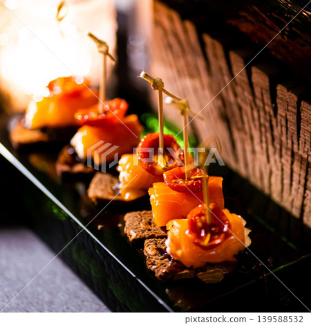 Pumpernickel bread sandwich snack with cured smoked salmon and fresh avocado served as close-up on a wooden cutting board Pumpernickel bread sandwich snack with cured smoked salmon and fresh avocado served as close-up on a wooden cutting board 139588532