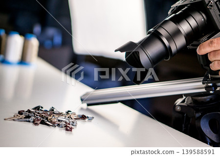 Making video of Metal zipper slide isolated on white. Assortment of zipper slides. Clothing element. Making video of Metal zipper slide isolated on white. Assortment of zipper slides. Clothing element. 139588591