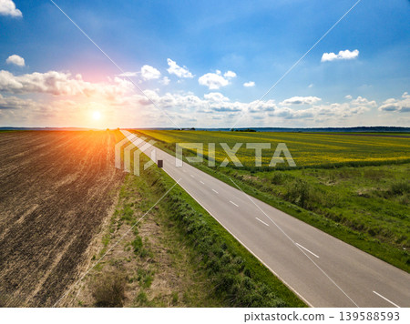 Drone image sunset in clouds with sunrays over road to horizon top wiew Drone image sunset in clouds with sunrays over road to horizon top wiew 139588593