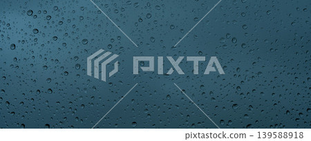 A rainy day window view. Rain drops on window. Condensed rain drop on the car glass window on a rainy day. Dew moisture condensation on wet mirror background. Fresh weather. Water raindrop bg 139588918