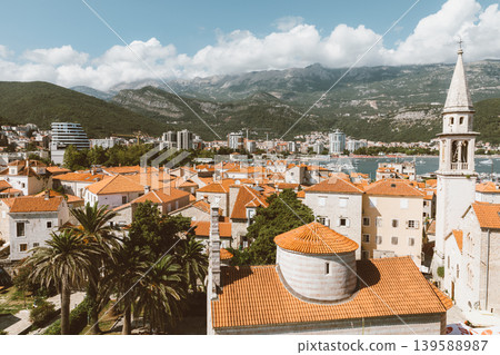 Budva old town rooftops and church bell tower with mountains in background 139588987
