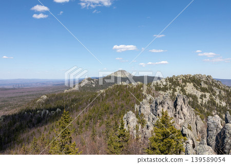 Taganay National Park mountain ridge with rocky cliffs and taiga forest panorama Taganay National Park mountain ridge with rocky cliffs and taiga forest panorama 139589054