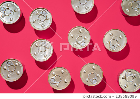 Pattern of metal tin cans on pink background Pattern of metal tin cans on pink background 139589099