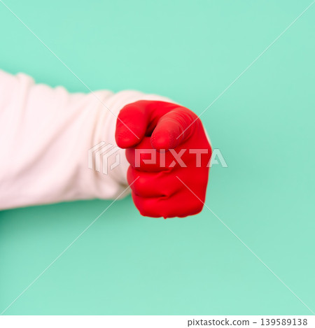 Red cleaning glove hand pointing at viewer Red cleaning glove hand pointing at viewer 139589138