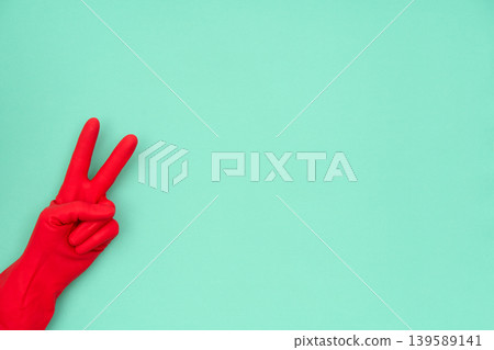 Hand in red cleaning glove showing victory peace sign 139589141