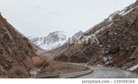 Winding mountain road through Too Ashuu Pass gorge in Kyrgyzstan in winter 139589168