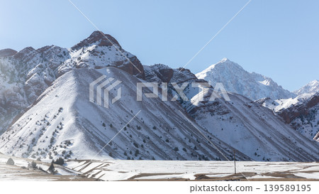 Snowy mountain landscape along Pamir Highway in Kyrgyzstan on sunny winter day Snowy mountain landscape along Pamir Highway in Kyrgyzstan on sunny winter day 139589195