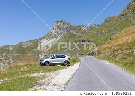Scenic mountain road with parked car in Durmitor National Park, Montenegro Scenic mountain road with parked car in Durmitor National Park, Montenegro 139589251