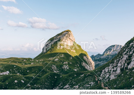 Scenic mountain peak and green valley landscape in Durmitor National Park Scenic mountain peak and green valley landscape in Durmitor National Park 139589266