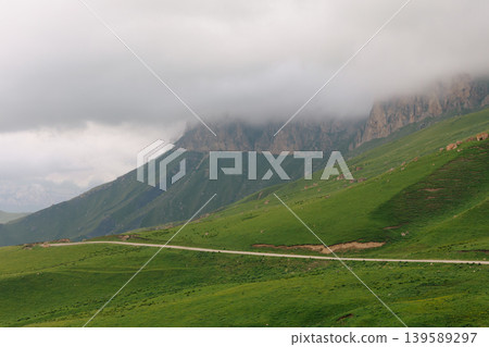 Misty mountain landscape with winding road near Aktoprak village, Caucasus Misty mountain landscape with winding road near Aktoprak village, Caucasus 139589297