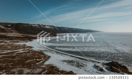 Winter shoreline and frozen water of Lake Baikal, Maloye More aerial panorama Winter shoreline and frozen water of Lake Baikal, Maloye More aerial panorama 139589331