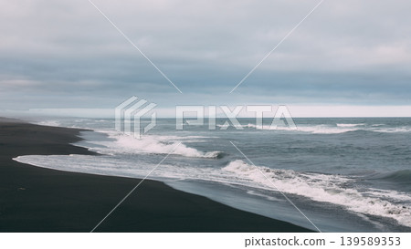 Khalaktyrsky Beach black sand coastline with waves under cloudy sky, Kamchatka Khalaktyrsky Beach black sand coastline with waves under cloudy sky, Kamchatka 139589353