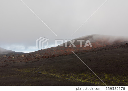 Misty volcanic landscape of Tolbachinsky Dol lava fields in Kamchatka, Russia Misty volcanic landscape of Tolbachinsky Dol lava fields in Kamchatka, Russia 139589376