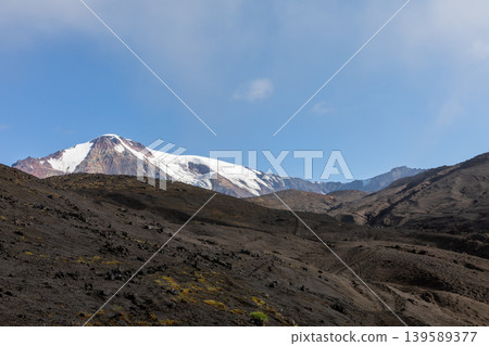 Tolbachinsky Dol volcanic valley with snowcapped mountain landscape, Kamchatka 139589377