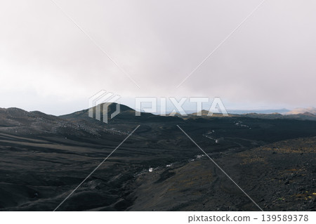 Tolbachinsky Dol volcanic landscape with black lava fields and distant hills Tolbachinsky Dol volcanic landscape with black lava fields and distant hills 139589378