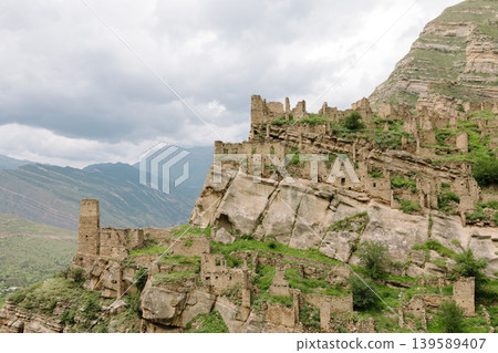 Ruins of the old mountain village of Kahib on rocky cliff in Dagestan Ruins of the old mountain village of Kahib on rocky cliff in Dagestan 139589407