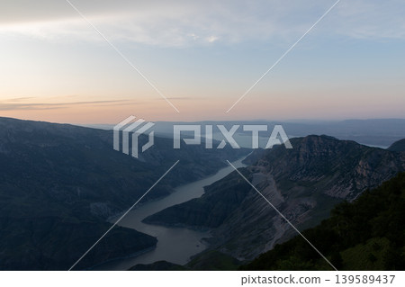 Sunset panorama of Sulak Canyon with winding river and mountain ridges 139589437