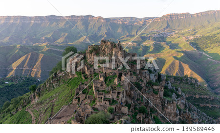 Mountain ruins of abandoned village of Gamsutl on rocky peak in Dagestan 139589446
