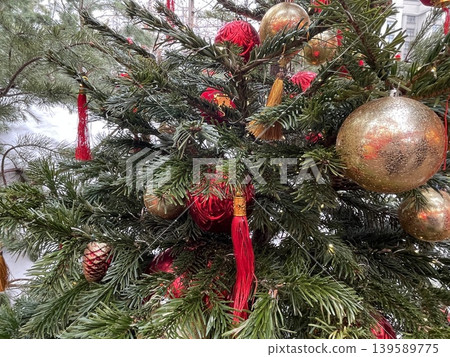 Christmas tree with red and gold ornaments and pine needles as festive decoration background 139589775