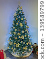 Beautiful Christmas tree decorated with golden ornaments fairy lights and festive holiday decor indoors. Cozy winter atmosphere with traditional seasonal celebration styling 139589799