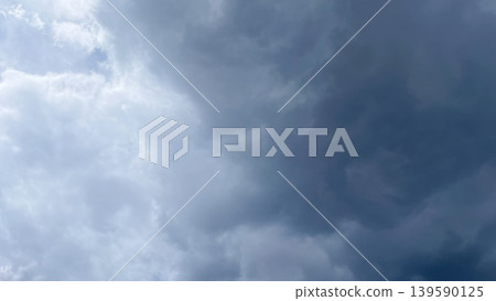 Dramatic overcast sky with contrasting light and dark grey storm clouds creating a moody atmosphere Dramatic overcast sky with contrasting light and dark grey storm clouds creating a moody atmosphere 139590125