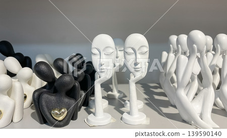 Set of black and white abstract ceramic figurines of couples with golden hearts for home interior decor Set of black and white abstract ceramic figurines of couples with golden hearts for home interior decor 139590140