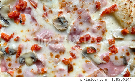 Top view close up of delicious pizza with melted mozzarella ham mushrooms and fresh diced tomatoes Top view close up of delicious pizza with melted mozzarella ham mushrooms and fresh diced tomatoes 139590144