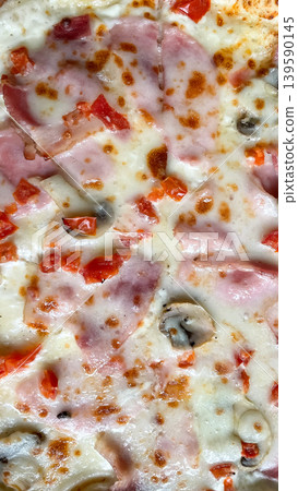 Top view close up of delicious pizza with melted mozzarella ham mushrooms and fresh diced tomatoes Top view close up of delicious pizza with melted mozzarella ham mushrooms and fresh diced tomatoes 139590145