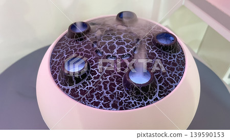 Ultrasonic aroma diffuser with a volcano lava design emitting mist and a calming blue led glow 139590153