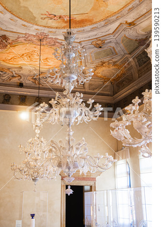 Murano glass chandelier hanging in elegant Venetian interior room decor Murano glass chandelier hanging in elegant Venetian interior room decor 139590213