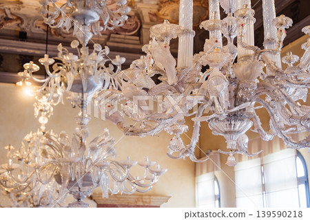 Murano glass chandelier hanging in elegant Venetian interior room decor Murano glass chandelier hanging in elegant Venetian interior room decor 139590218
