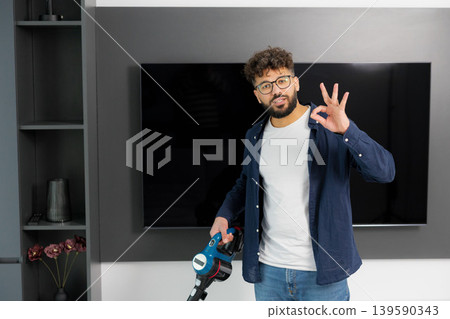 Man showing approval for effective home cleaning Man showing approval for effective home cleaning 139590343