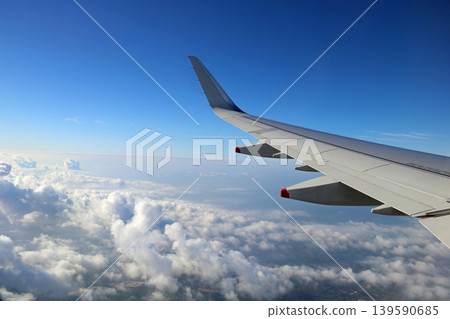 View of Aircraft Wing Over Clouds Prior to Landing View of Aircraft Wing Over Clouds Prior to Landing 139590685