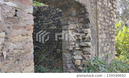 Tilla Jogian ancient temple interior stone arch and rough walls Pakistan 139590692