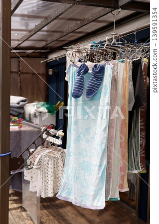 Laundry hanging on the clothesline on the terrace. Towels and clothes. Outdoors. 139591354