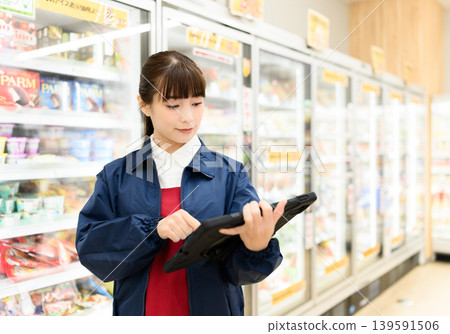 Women manage inventory using tablets Women manage inventory using tablets 139591506