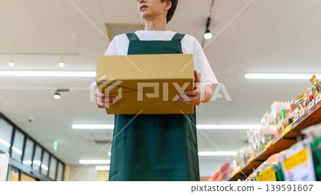 Shop staff who carry bags inside the store Shop staff who carry bags inside the store 139591607