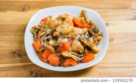 Braised chicken wings and carrots, Japanese-style stew with mushrooms, wooden table Braised chicken wings and carrots, Japanese-style stew with mushrooms, wooden table 139592270