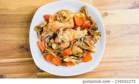 Braised chicken wings and carrots, Japanese-style stew with mushrooms, wooden table Braised chicken wings and carrots, Japanese-style stew with mushrooms, wooden table 139592275