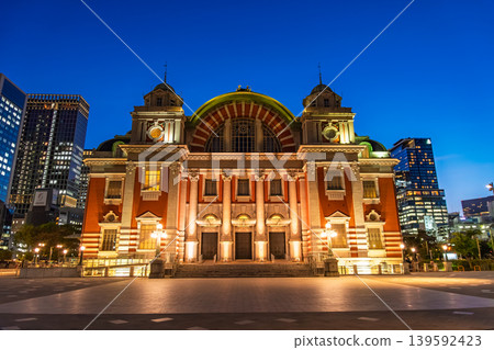 Osaka City Central Public Hall, Osaka Prefecture: The red brick building stands out against the blue hour sky as it is lit up. 139592423
